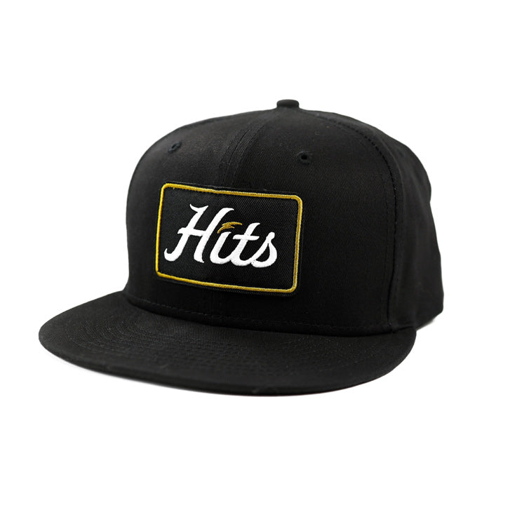 hits black hat with gold box logo on white background
